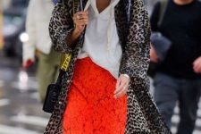 With leopard printed midi coat, black and yellow bag, golden earrings and green pumps