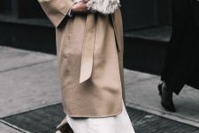 With linen trousers, white long cardigan, beige belted coat and black and beige low heeled shoes