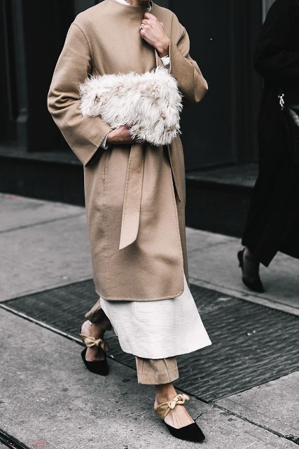 With linen trousers, white long cardigan, beige belted coat and black and beige low heeled shoes