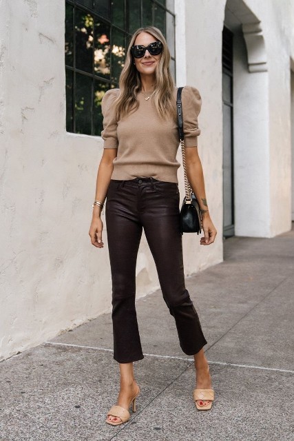 With oversized sunglasses, black leather chain strap bag, brown leather flare cropped pants and beige leather heeled mules