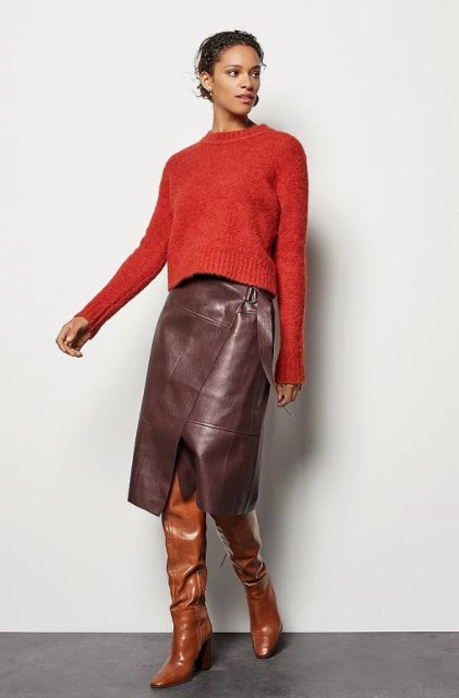With red long sleeved sweater and brown leather high boots