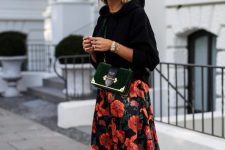 With rounded sunglasses, golden and emerald green velvet crossbody bag and white, green and red lace up flat shoes