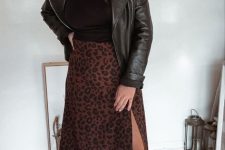 With silver earrings, leopard printed midi skirt and black low heeled ankle boots