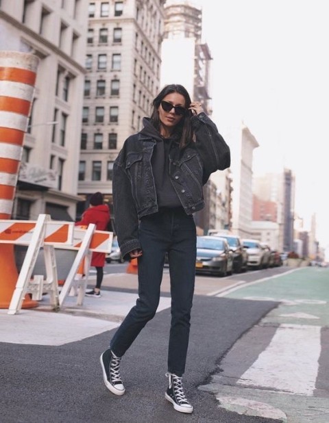 With sunglasses, black cropped jeans and black and white lace up sneakers
