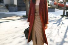 a beige cami rop, a plaid midi pencil skirt with a front slit, brown velvet shoes, a rust-colroed coat and a black bag
