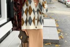 a beige slip midi dress, neutral lace up boots, a diamond print cardigan and a brown printed bag for work
