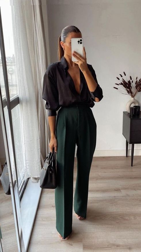 a black shirt, dark green trousers, a black bag and chic minimalist shoes are a perfect combo for work