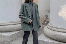 a casual work outfit with a grey turtleneck, trousers, a green oversized blazer and grey and white sneakers