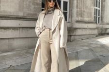 a chic all-neutral outfit with a grey turtleneck, creamy pants, a creamy midi coat, white booties for late fall or winter