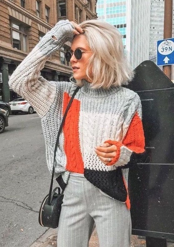 a color block chunky sweater, grey pinstripe trousers, a black round bag for a bright fall outfit