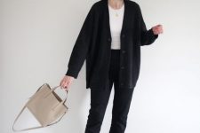 a contrasting fall work outfit with a white top, black cropped jeans, a black oversized cardigan, a beige tote