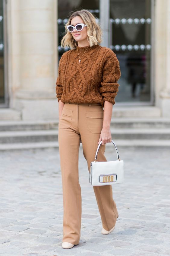 a cozy fall look with a brown patterned sweater, beige pants, nude boots, a white bag and retro sunglasses