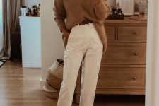a cozy fall outfit with a beige oversized sweater, white trousers, a brown belt and nude ankle strap shoes
