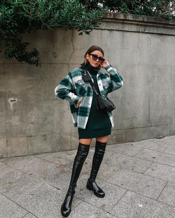 a dark grene turtleneck sweater dress, a plaid shirt jacket, black over the knee boots and a small black bag