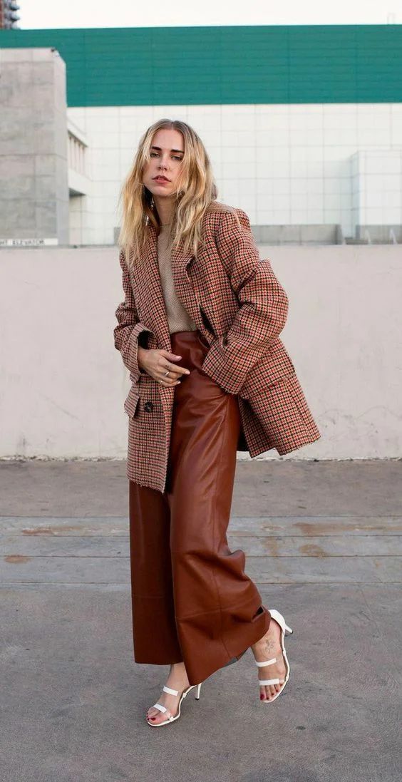 a greige t-shirt, brown leather culottes, a red plaid oversized blazer, white strappy shoes for a chic fall work look