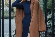 a navy midi dress with long sleeves, a brown midi coat, a brown tote for a chic formal work outfit