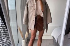 a neutral V-neck jumper, a burgundy suede wrap mini skirt, nude chelsea boots, a neutral shirt jacket for a sexy look