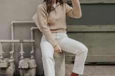 a neutral fall work look with a white t-shirt and cropped jeans, brown boots, a beige ribbed sweater and a white bag