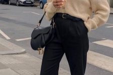 a simple fall work look with black cropped pants, a belt and a bag, a neutral cardigan, white sneakers