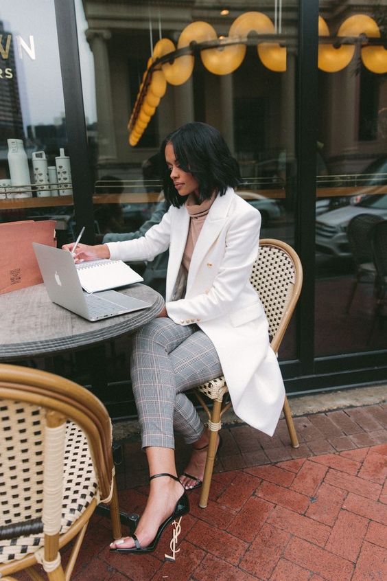 a sophisticated neutral fall work look with a beige turtleneck, grey plaid pants, a white trench and black stappy shoes