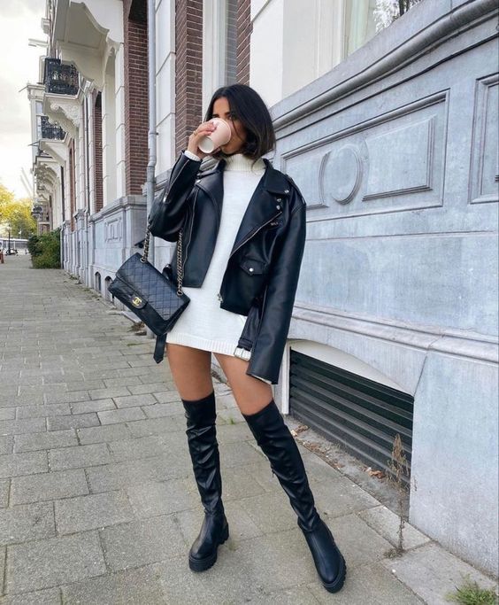 a stylish and catchy fall look with a white mini sweater dress, black over the knee boots, a black leather jacket and a black bag