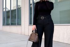 a total black fall work outfit with a turtleneck, flare jeans, a printed bag is a great idea to rock