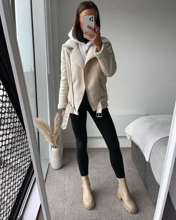 a white hoodie, a neutral shearling jacket, black leggings, nude Chelsea boots for a cold fall day
