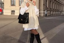 a white shirtdress, a creamy sleeveless sweater, black over the knee boots and a large black bag