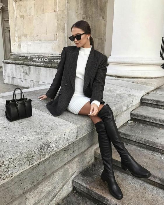 a white sweaterdress, a black oversized blazer, black over the knee boots, a small black bag for a work look
