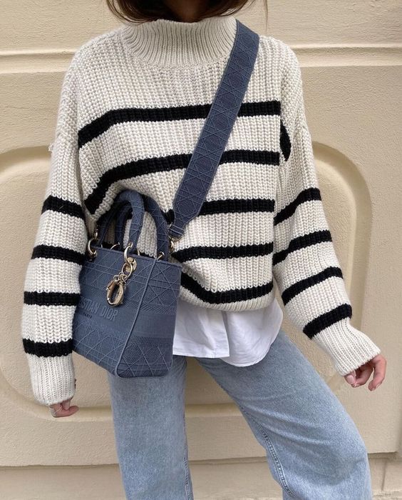 a white tee, a Breton stripe sweater, light blue jeans, a navy denim bag for the fall