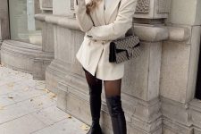 a white turtleneck, a creamy blazer, black shorts, black over the knee boots and a printed bag for the fall