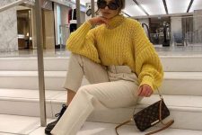 a yellow chunky knit sweater, neutral leather trousers, a printed bag and black platform shoes for the fall