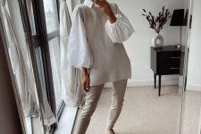 an all-neutral fall outfit with a white shirt with puff sleeves, a ribbed waistcoat, creamy leather pants, creamy Chelsea boots
