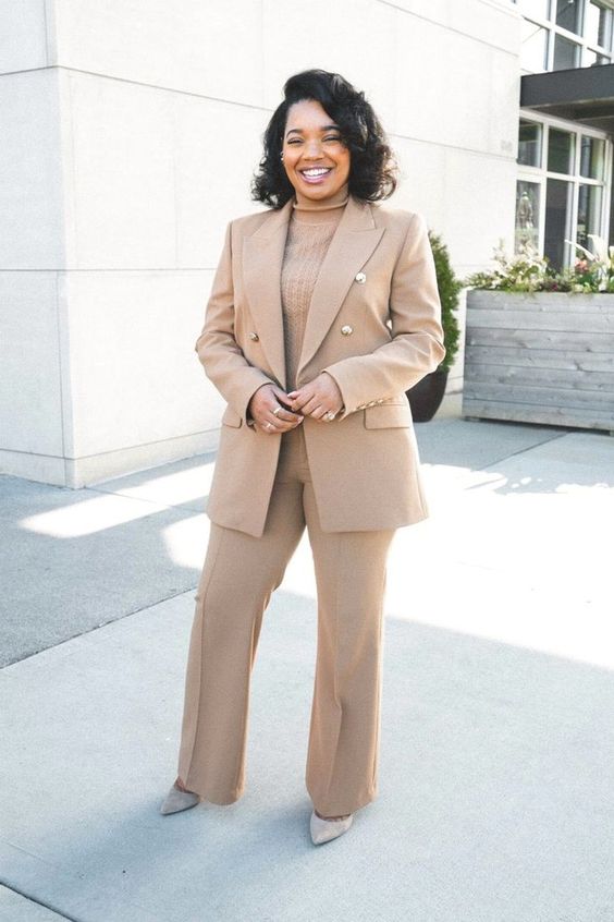 an all neutral fall work outfit with a beige pantsuit, flare pants, a matching turtleneck and grey shoes