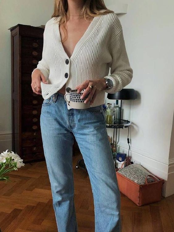 a simple and classy outfit with a creamy cardigan, blue jeans and a watch are a lovely idea to rock