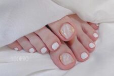 22 a super delicate pedicure in white and blush with a marble effect and gold foil is a dreamy and lovely solution