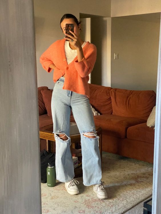 a white t-shirt, a cropped orange cardigan, blue ripped jeans, white sneakers are great for the fall