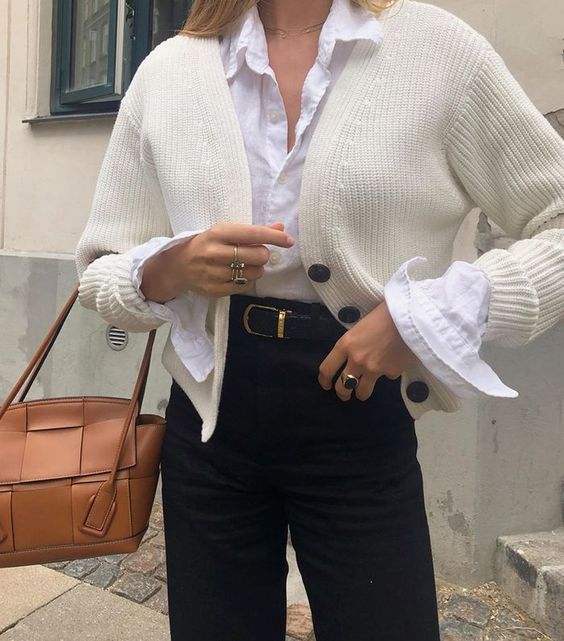 a work outfit with a white shirt, a creamy cropped cardigan, black jeans and a belt, a brown bag