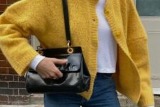 26 navy jeans, a white cropped t-shirt, a yellow cropped cardigan and a black bag are a great combo for the fall