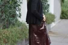 With black cardigan, shirt, black tights and black leather ankle boots