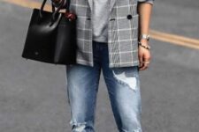 With blue distressed cuffed jeans, black leather tote bag and black ankle strap high heels