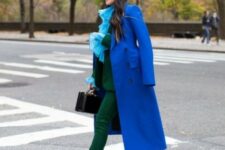 With light blue ruffled blouse, black bag and blue pumps