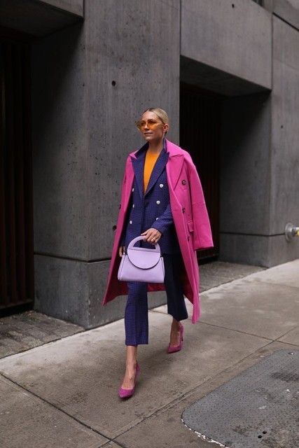 With orange shirt, sunglasses, lilac leather bag and pink suede pumps