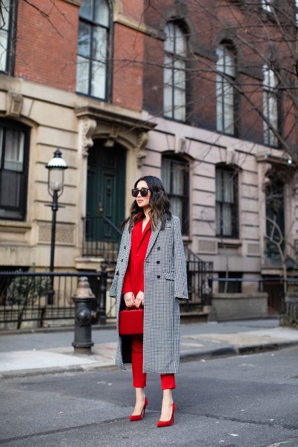 With oversized sunglasses, red bag and red pumps