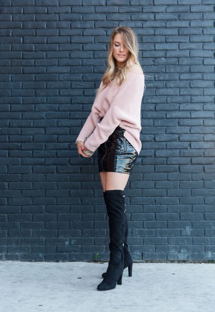 With pale pink oversized sweater, white bag and black suede over the knee boots