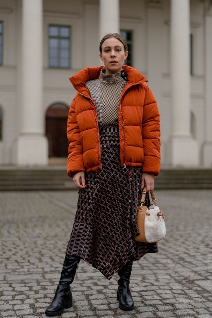 With printed asymmetrical midi skirt, black leather high boots and brown and white bag