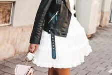 With rounded sunglasses, white leather mini bag and black leather lace up flat mid calf boots