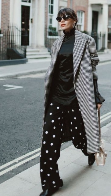 With sunglasses, black and white polka dot trousers, black boots and beige embellished chain strap bag