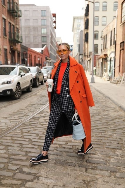 With sunglasses, orange sweatshirt, mint green bag and black patent leather lace up platform shoes