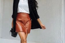 With white t-shirt, black long blazer, black bag and black ankle boots